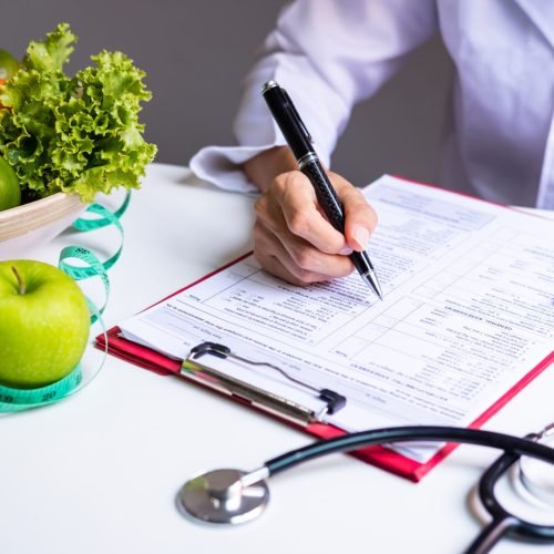 Nutritionist with healthy fruit, vegetable and measuring tape working, Right nutrition and diet concept